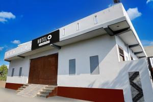 a building with a sign that reads mielo at Hotel O Brij Ghat Mukteshwar Formerly Brijwasi Guest House in Kankather