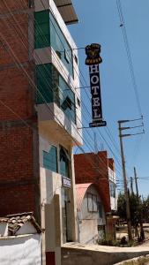 a building with a sign on the side of it at Hotel Huancayo - El Toro Wanka in San Antonio +4 photos
