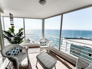 a balcony with chairs and a view of the ocean at Hermoso depto vista al mar frente a la Playa in Concón
