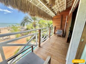 a balcony of a house with a view of the beach at Vila Pukara - Moitas in Praia de Moitas