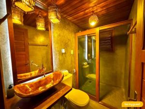 a bathroom with a wooden sink and a toilet at Vila Pukara - Moitas in Praia de Moitas +73 photos