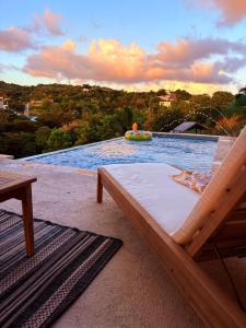 a bed sitting on a patio next to a pool at Lady Aura Casitas in Cabo Rojo, Puerto Rico in Cabo Rojo