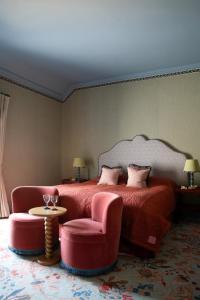 a bedroom with a bed and a chair and a table at Armada House in Spanish Point +11 photos