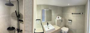 a bathroom with a sink and a toilet at Karaibes Hotel in Le Gosier