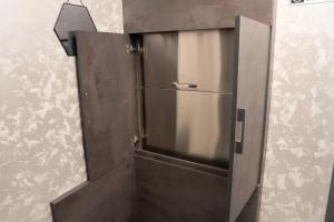 a metal door in a room with a wall at Prime Suites Hotel in Yerevan +156 photos