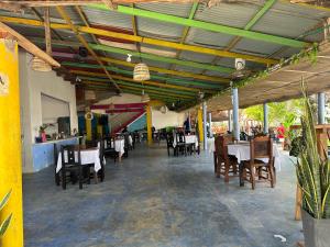 a dining room with tables and chairs in a restaurant at Yokohama tour in Necoclí +12 photos