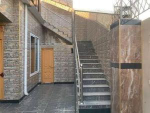 a staircase in a brick building with a brown door at Ibrahim flats Mardan in Mardan