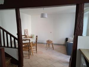 a dining room with a table and a table and chairs at Maison confortable sur RN6 in Armeau
