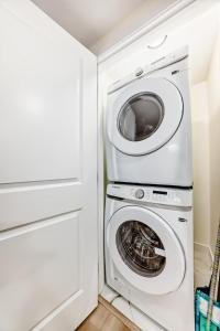 a laundry room with a washer and dryer at KimzNest in Edmonton