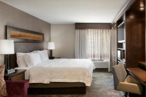 a hotel room with a bed and a window at Hampton Inn Jackson Hole in Jackson +26 photos