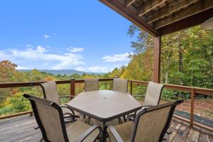 a table and chairs on a deck with a view at Parkway Place in Bamboo