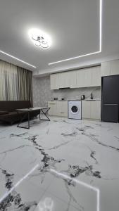 a living room with a marble floor and a table at Airport Inn in Pʼarakʼar