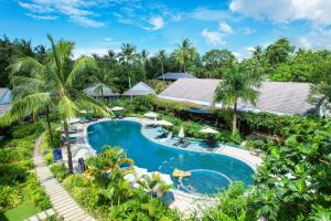 an aerial view of a resort pool with palm trees at Kingo Retreat Resort in Phu Quoc