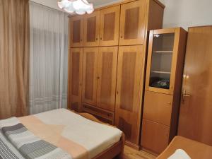 a bedroom with a bed and a wooden cabinet at Φουντούκι in Veria