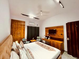 ハリドワールにあるHotel Aura, Top Rated & Most Awarded Hotel In Haridwarのベッドとソファのあるホテルの部屋