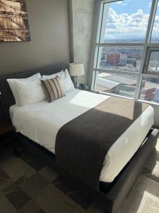 a large bed in a room with a large window at SAIT Residence & Conference Centre - Calgary in Calgary