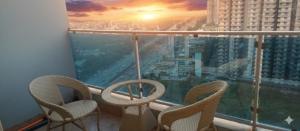 a balcony with chairs and a view of a city at Enjoy your day without any disturbance in Ghaziabad