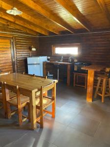 a kitchen with a wooden table and a kitchen with a sink at Complejo La Morenita in Azul
