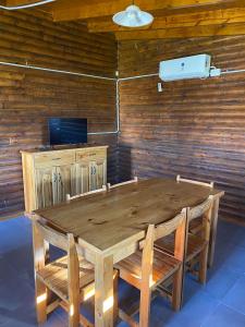 a wooden table and chairs in a room at Complejo La Morenita in Azul