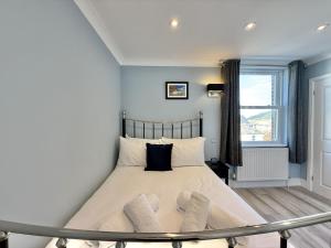 a bedroom with a bed with two socks on it at Sunnybeach in Seaton