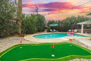 a golf course with a pool and a putting green at Saltwater Pool - HotTub - Games - Good Vibes Only! in Indio