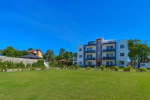 a building with a large lawn in front of it at 3 Bedroom Penthouse with private Rooftop Terrace in Sosúa
