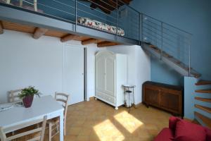 sala de estar con escalera y mesa en La Gallina, en Artogne