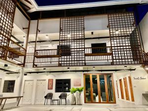 a room with chairs and tables in a building at Secret Corner Boutique Hostel in Chiang Rai
