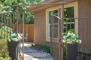 a garden with a gate with flowers in it at Tranquil Quiet Mountain Home w Private Garden in Chino Hills