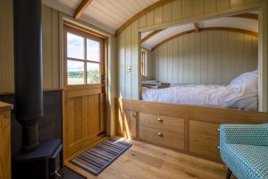 a small bedroom with a bed and a window at Little Park Farm Queen Anne Farmhouse & Apartments in Stratfield Mortimer