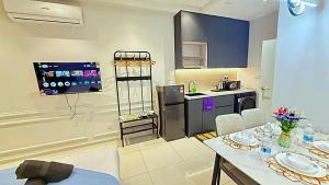 a kitchen with a table and chairs and a kitchen with at Majestic Residence Suites KLCC in Kuala Lumpur