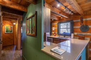 a kitchen with green walls and a counter top at A River Runs Through It in Valle Crucis +59 photos