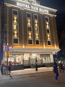 a hotel type building with people standing in front of it at Hotel The Elite in Jabalpur