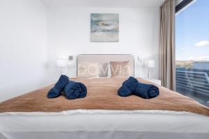 a bedroom with a large bed with blue pillows at Modern 2BD Apartment with Huge Terrace NaviGolf in Málaga +17 photos