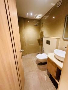 a bathroom with two sinks and a toilet at Hotel The Elite in Jabalpur +20 photos