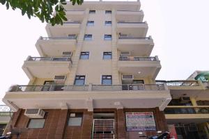 a tall building with a balcony on top of it at Collection O DLF Cyberhub Gurugram in Gurgaon +8 photos