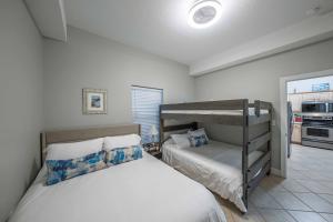 a bedroom with two beds and a bunk bed at Luxury 2BR Beachfront Condo - Panama City Beach in Panama City Beach +30 photos