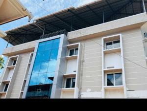a building with a reflection of the sky in the windows at Collection O Aluva Kinfra Hi-Tech Park in Alwaye +9 photos