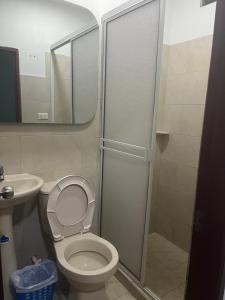 a bathroom with a shower and a toilet and a sink at Hotel Maria del Mar planeta Rica in Planeta Rica