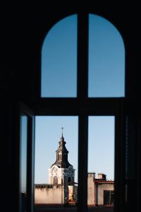 a view of a church through a window at Apartament Studio Migot in Przemyśl