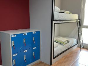 a bedroom with a bunk bed and a mirror at Hego Haize Albergue Hostel in Zarautz