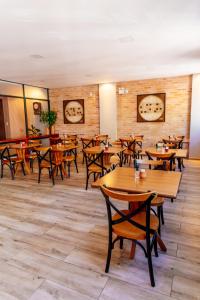 a dining room with wooden tables and chairs at Vila de Cunha in Cunha