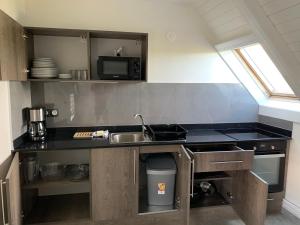 a kitchen with a sink and a counter top at Karaibes Residence in Le Gosier
