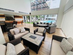 a large living room with couches and a piano at Life Bucerías, Modern Studio Near the Beach in Bucerías