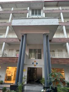 a building with blue columns in front of it at Ganga villa in Jāmb +5 photos