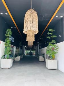 a large lobby with a chandelier and potted plants at Life Bucerías, Modern Studio Near the Beach in Bucerías