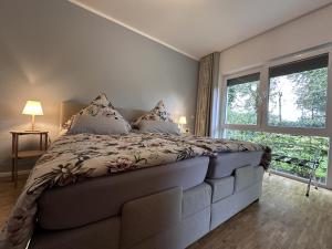 une chambre avec un grand lit avec une grande fenêtre dans l'établissement Ferienwohnung Seeperle, à Bad Zwischenahn