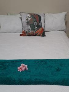 a pillow with a picture of a woman on a bed at Overflowing Guest House in Durban
