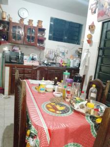 a table with a red table cloth with food on it at ALUGUEL 500,00 diária in Belém