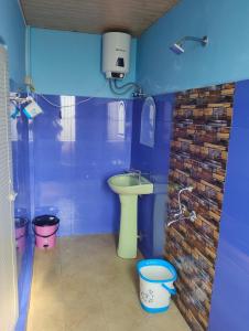 une salle de bain bleue avec un lavabo et une douche dans l'établissement DADA TOURIST COTTAGE & Camping site, à Cherrapunji